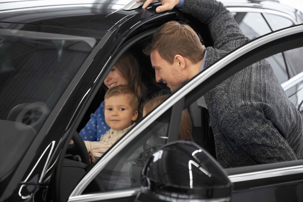Family talking with a dealership sales associate